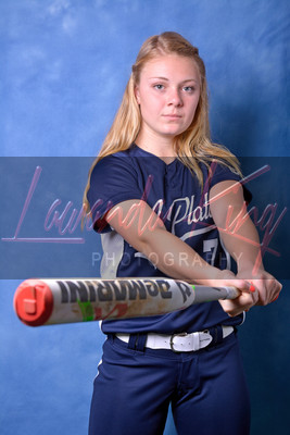 High school senior swinging baseball bat during studio session at Lawanda King Photography