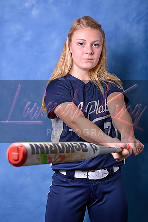 High school senior swinging baseball bat during studio session at Lawanda King Photography