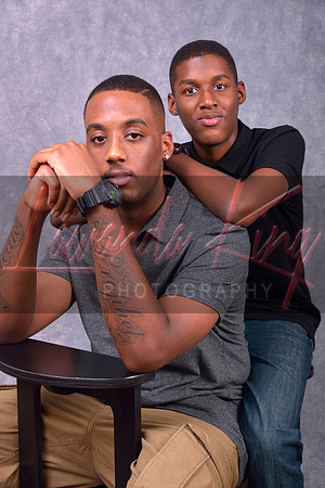 Studio portrait of two young brothers seated on bench at Lawanda King Photography studio