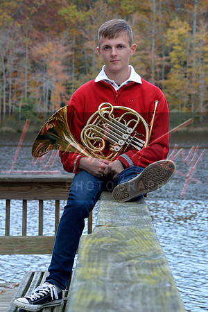High school senior holding French horn during studio session at Gilbert Run Park