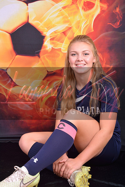 High school senior soccer player with fire soccer ball background at Lawanda King Photography studio