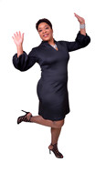 Creative full-length headshot of woman expressing excitement with raised arms and leg