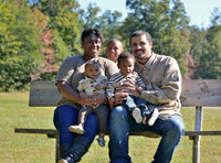 Family portrait sitting on park bench in Charles County MD during golden hour