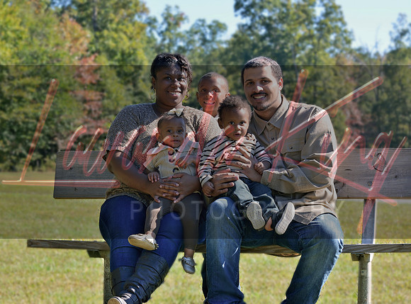 Family portrait sitting on park bench in Charles County MD during golden hour