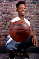 Graduating athlete with basketball at Lawanda King Photography