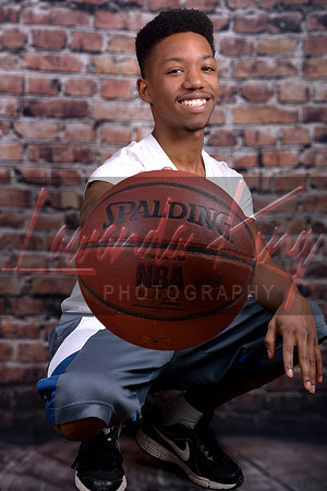 Graduating athlete with basketball at Lawanda King Photography