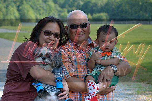 Family portrait in park with parents, baby boy and dog in White Plains, MD
