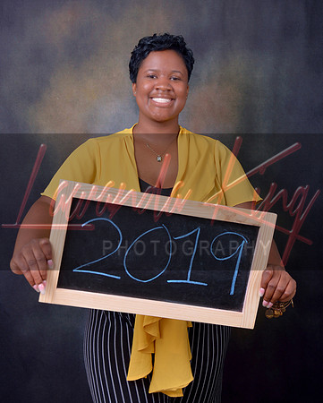 Graduating senior with chalkboard sign at Lawanda King Photography studio