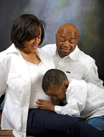 Family maternity photo with toddler hugging mom's belly at Lawanda King Photography studio