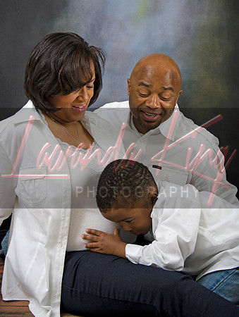 Family maternity photo with toddler hugging mom's belly at Lawanda King Photography studio